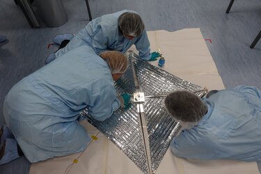 Students inspecting the drag sail at the CubeSat Support Facility